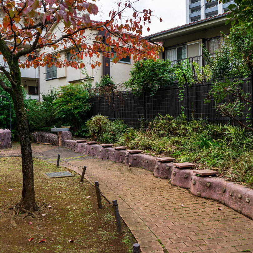 曲線を描く遊歩道と個性的なモニュメントベンチ ゆったり広場児童遊園